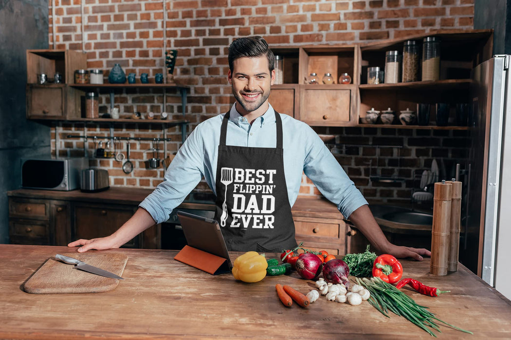 VAGAVY - Best Flippin Dad Ever Dad Apron with Pockets - Bottle Opener and Gift Box Included - Birthday, Father’s Day Grilling Gifts for Papa, Husband - Black Barbeque Apron for Daddy Men - Grill Parts America